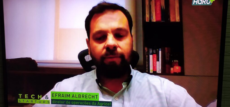Na imagem está o diretor de operações da startup Agricef, Efraim Albrecht, em uma tela de televisão vestindo uma camisa polo na cor branca.
