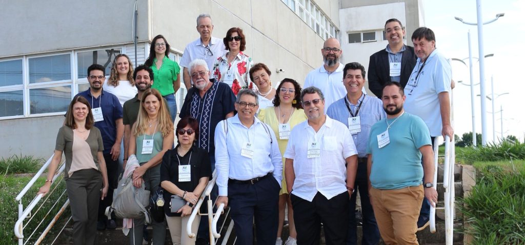 Foto colorida externa mostra cerca de 20 participantes do Encontro Innovagro Brasil 2024 – Ruta de Innovación posicionados em uma escadaria do lado de fora de um dos prédio do Parque Científico e Tecnológico da Unicamp. Fim da descrição.